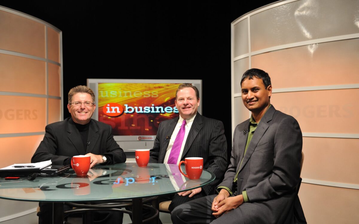 Three men sitting at a business talk show.