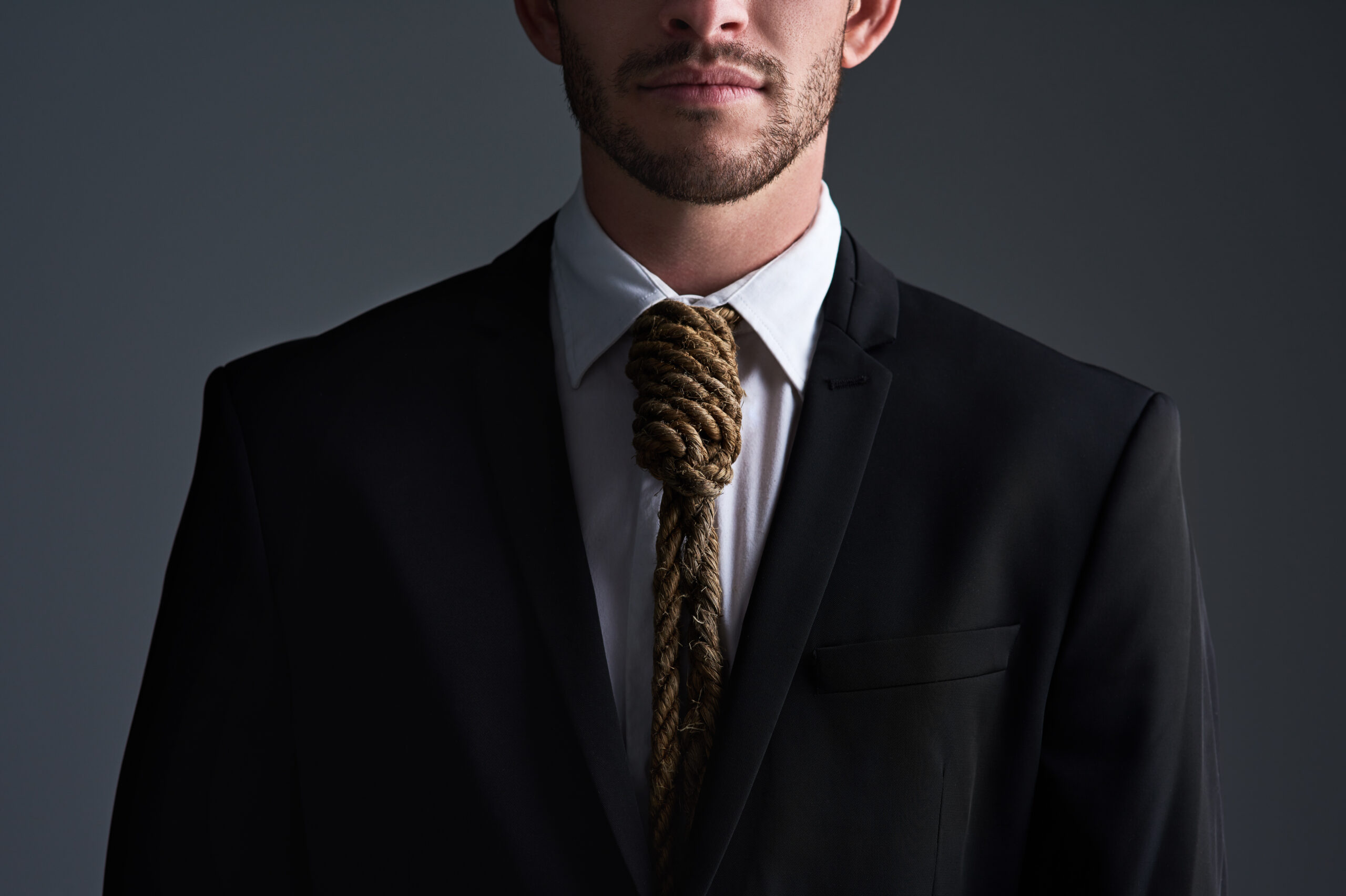 Man in suit with rope necktie.