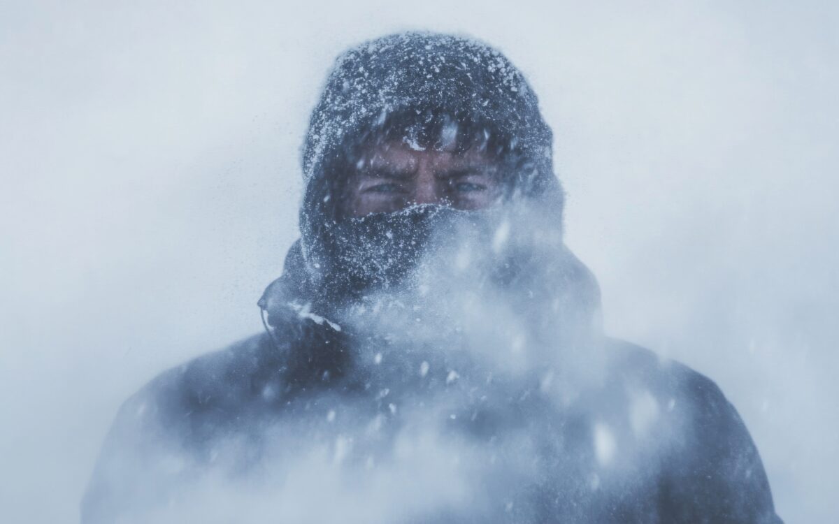 Person in snowstorm with covered face.