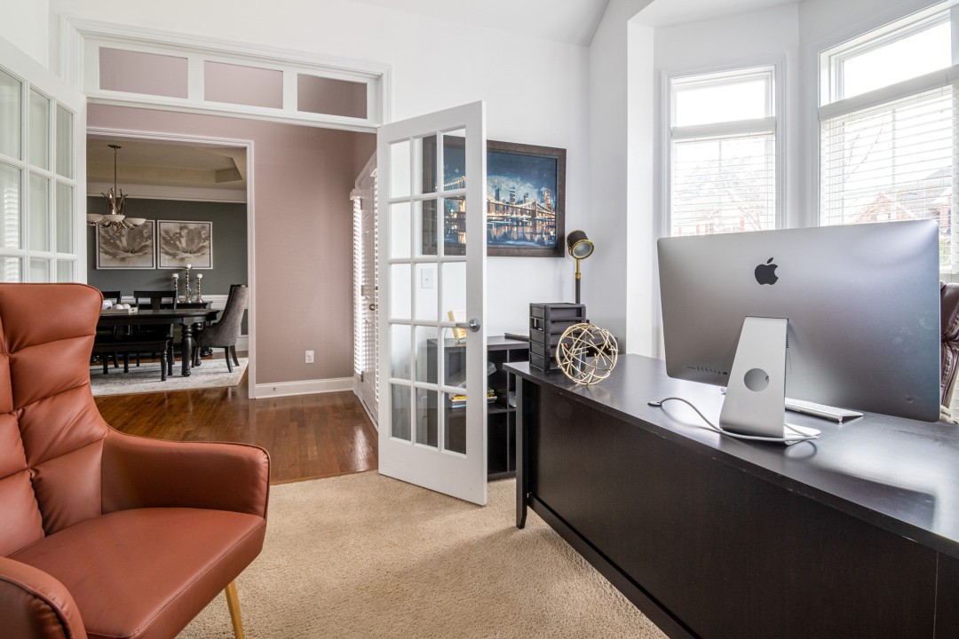 Home office with desk and armchair.